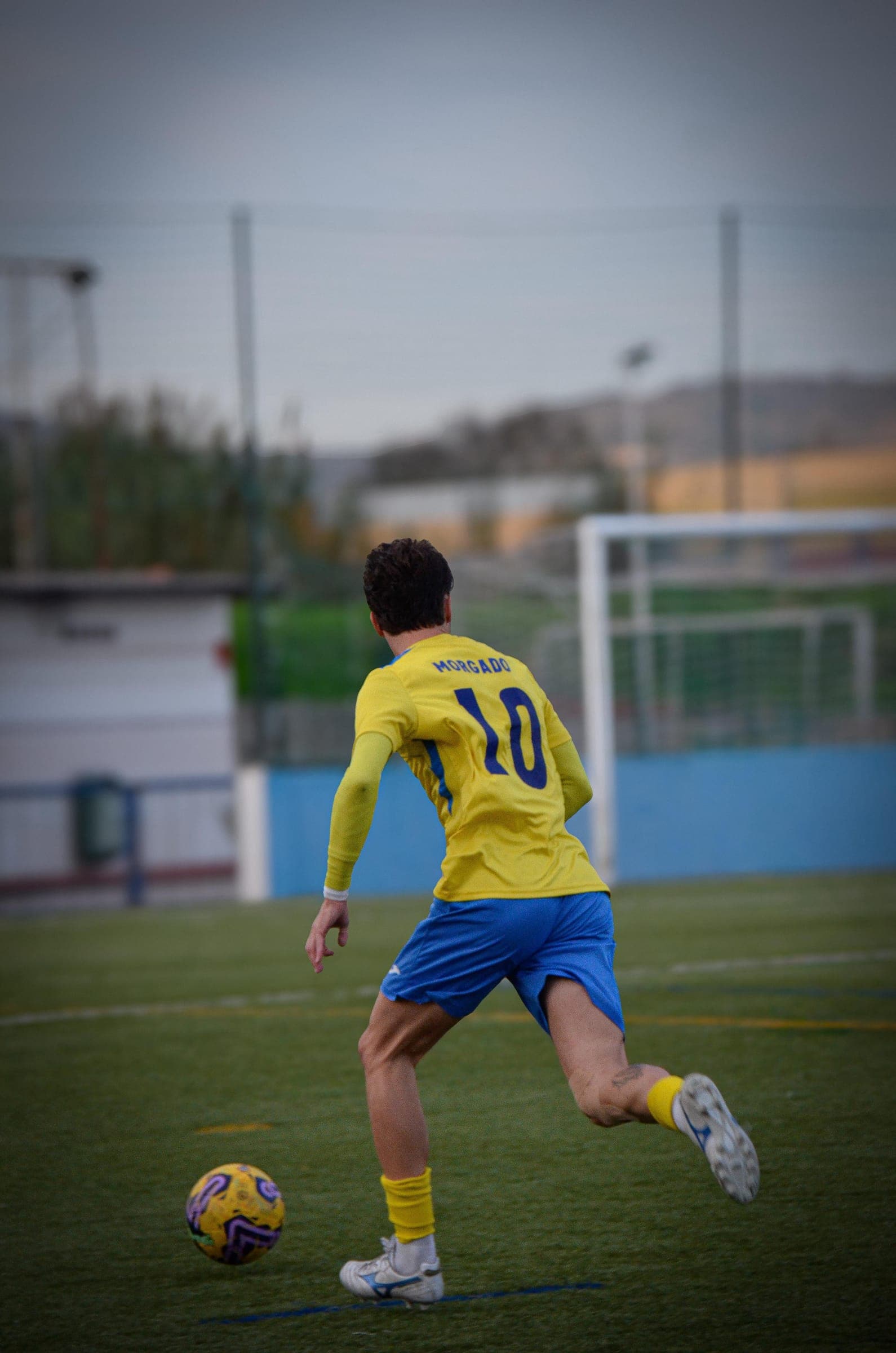 Bobadelense number 10 Morgado driving at goal at dusk