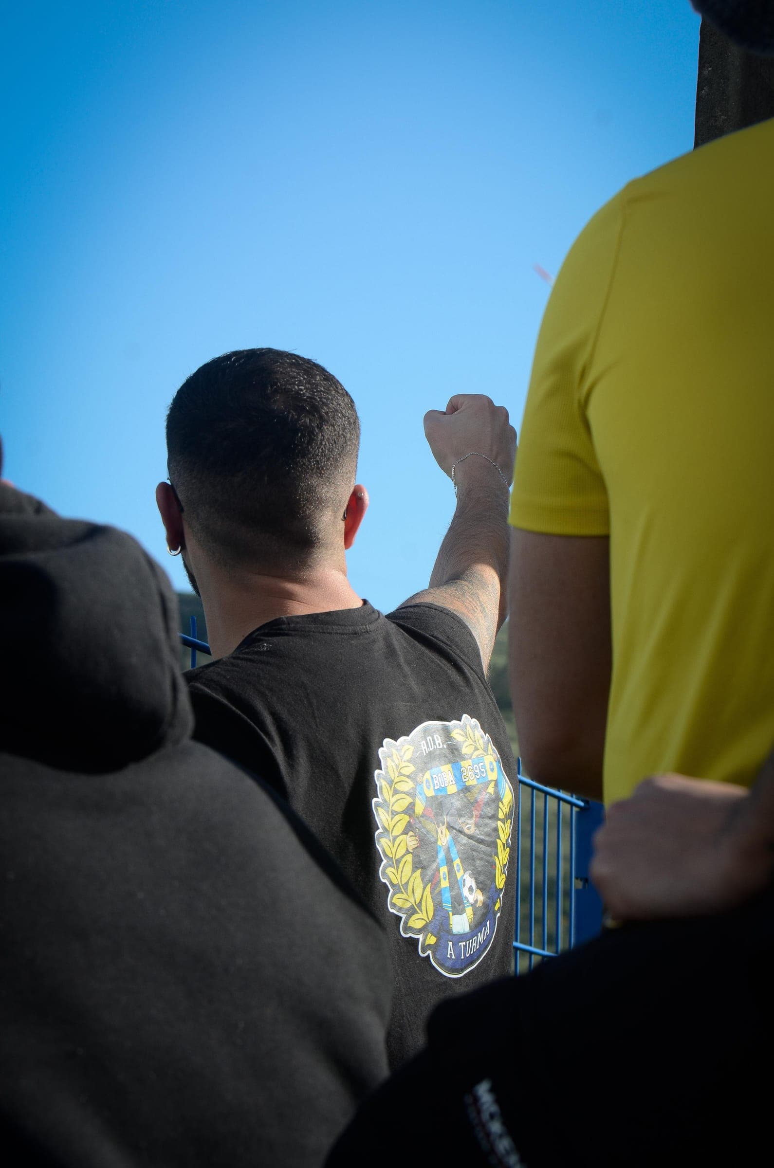 Supporter raising a fist against the sky in the stand